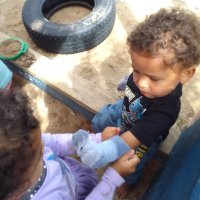 PK Harrison's big sister helps him with his socks